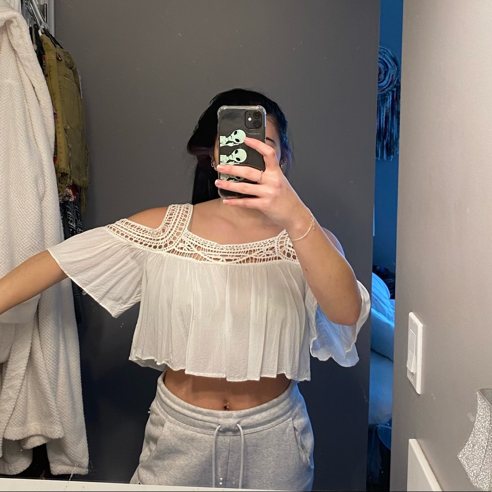 White crop top with short sleeves and shoulder cut